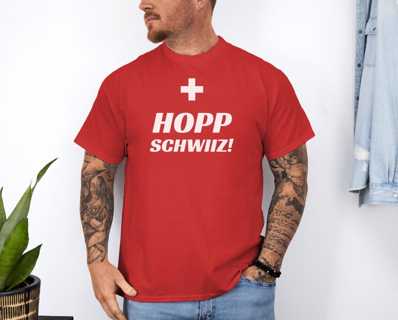 May include: Red t-shirt with a white Swiss flag and the text "HOPP SCHWIIZ!"
