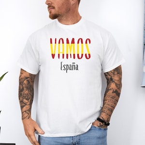 May include: White t-shirt with the text "VAMOS" in red and yellow, and "Espa&ntilde;a" in black below it.
