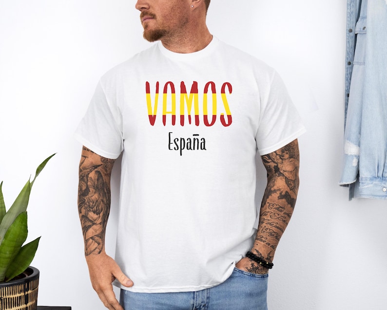 May include: White t-shirt with the text "VAMOS" in red and yellow, and "Espa&ntilde;a" in black below it.