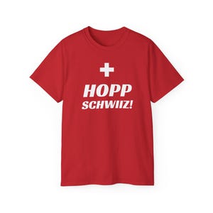 May include: Red t-shirt with a white Swiss flag and the text "HOPP SCHWIIZ!"