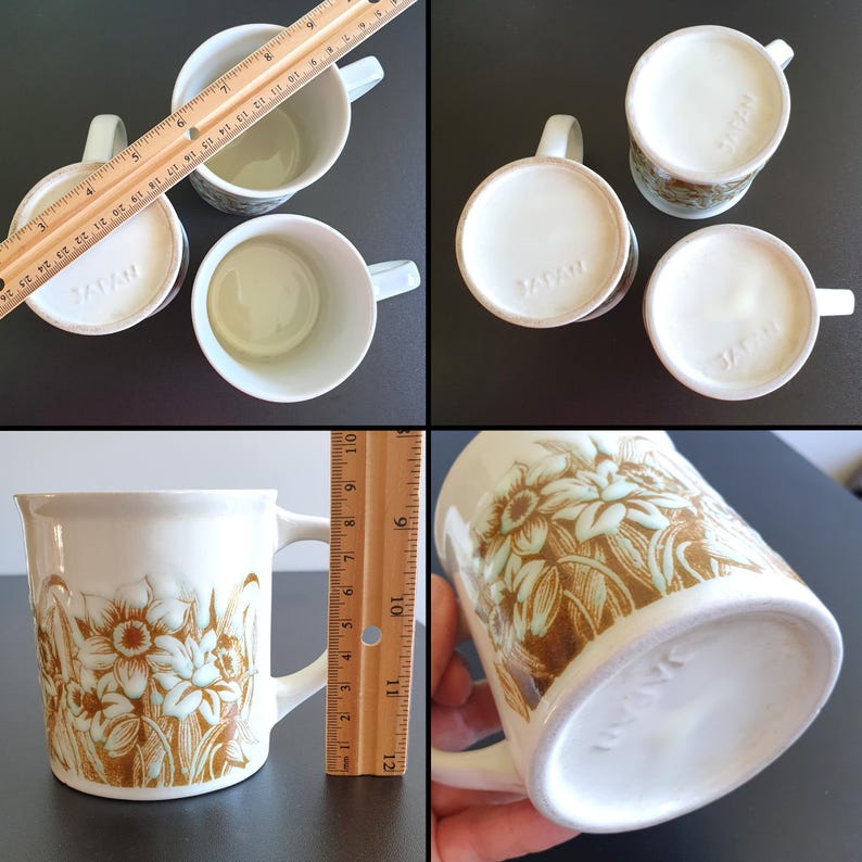 May include: Set of four vintage white ceramic mugs with floral designs in brown and light green. Each mug has a handle and is marked "JAPAN" on the bottom. The mugs measure approximately 3.5 inches in diameter and 4 inches tall.