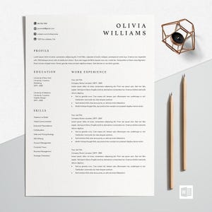 May include: A white resume template featuring the name Olivia Williams in black text, with sections for profile, education, work experience, and skills. The document is accompanied by two wooden pencils and a geometric copper wire candle holder.