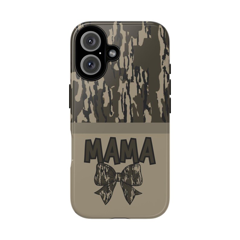 May include: A phone case with a camouflage pattern on the top half and a tan bottom half. The word "MAMA" is printed in dark gray block letters, with a bow graphic below it. The case has a dual-lens camera cutout.