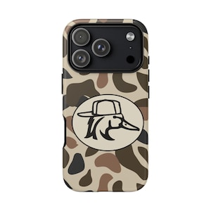 May include: A camouflage-patterned phone case with a duck logo. The case features a brown, tan, and black pattern. The duck logo is in a white oval and depicts a duck wearing a hat. The phone case has three camera lenses.