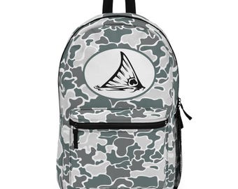 May include: A gray and white camouflage backpack with a black top handle and zipper. The front features a white oval with a black and white graphic of a fish tail. A black zipper pocket and side mesh pocket are also visible.