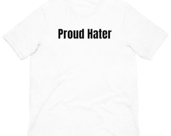 May include: White t-shirt with the text "Proud Hater" printed in black across the chest. The shirt has short sleeves and a crew neck. The fabric appears to be a soft, lightweight material.