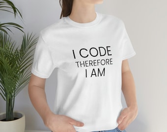 May include: White t-shirt with black text that reads "I CODE THEREFORE I AM".