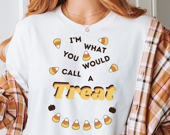 May include: White t-shirt with a graphic of candy corn and the text "I'm what you would call a treat".