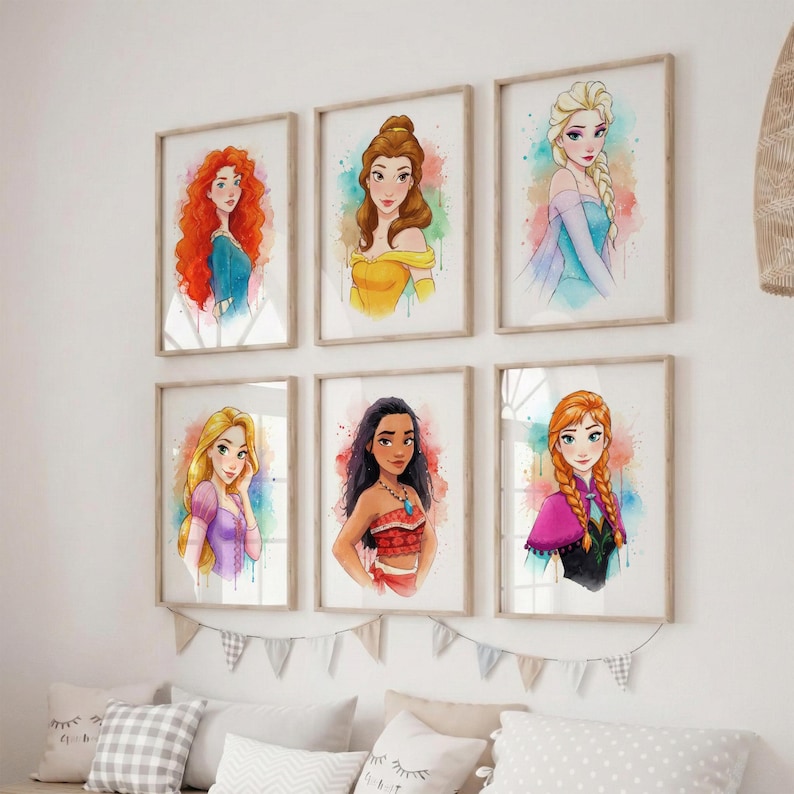 May include: Set of six framed watercolor prints featuring Disney princesses. Each portrait showcases a different princess with vibrant colors and a watercolor effect. The frames are a light wood color, and the prints are displayed on a white wall.