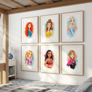 May include: Six framed watercolor prints of animated princesses. Each portrait features a different princess with vibrant colors and a watercolor effect. The frames are a light wood color, and the prints are displayed on a white wall.