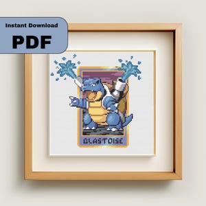 May include: Framed cross-stitch art featuring a blue Blastoise character with water blasts. The artwork is set against a white background and framed in a light brown wooden frame. The text "BLASTOISE" is at the bottom of the image. The words "Instant Download PDF" are in the upper left corner.