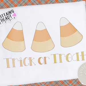 May include: Three yellow and white candy corn designs with the text "Trick or Treat" in a gold font.