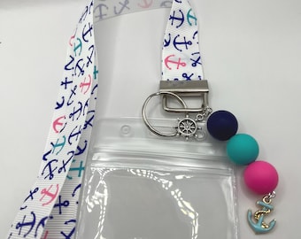 Cruise lanyard, multi-colored anchor ribbon, cute little charms and silicone beads. Comes with card holder. Charms and beads may vary.