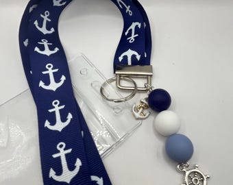 Cruise lanyard, 2 colors navy blue or red anchor ribbon, cute little charms and silicone beads. Comes with card holder.