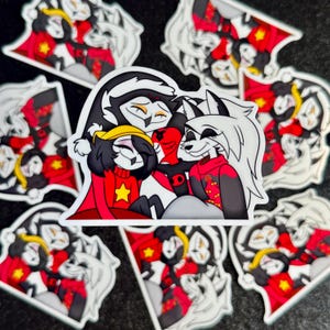 May include: Four cartoon characters, a black and white wolf, a black and white cat, a black and white cat with a red star on its chest, and a black and white cat with a red star on its chest, are hugging each other. The characters are all wearing red and white clothing. The background is a black and white checkered pattern.