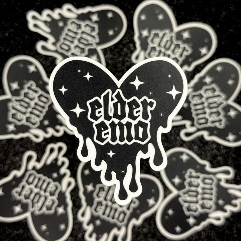 May include: Black and white sticker with a dripping heart shape. The heart has stars and the text "elder emo" inside.