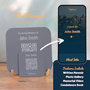 May include: A gray square plaque with the text "In Loving Memory of John Smith" and a QR code. A smaller gray square plaque with the text "John Smith" and a QR code is below the larger plaque. Both plaques are on a gold stand. A smartphone screen shows a blue background with the text "My Memoir", "a memoir for John Smith", and "About John". The screen also shows the text "Features Include", "Written Memoir", "Photo Gallery", "Memorial Video", and "Condolence Book".