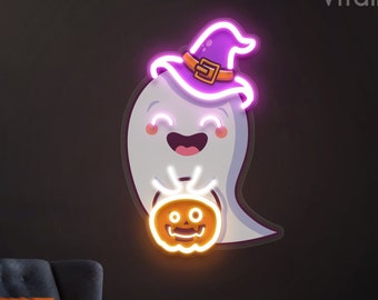 May include: A neon sign of a friendly ghost wearing a purple witch hat and holding a glowing jack-o'-lantern. The sign is mounted on a dark wall, with a matching pumpkin-themed pillow and pumpkins on the floor, creating a Halloween theme.