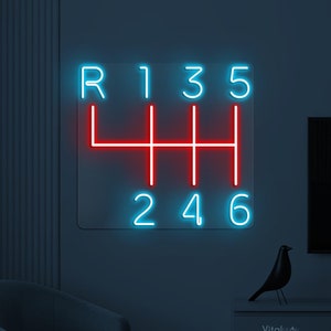 May include: Neon sign depicting a car's gear shift pattern. The numbers 1, 3, 5, 2, 4, and 6 are in blue neon, while the 'R' and the gear shift pattern are in red neon.