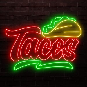 May include: A neon sign with the word "Tacos" in red script, with a green underline. Above the word is a neon taco in yellow and green. The sign is against a dark brick wall.
