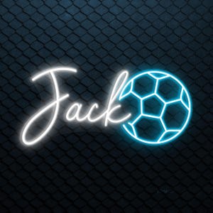 May include: Neon sign with the name "Jack" in white script, accompanied by a blue soccer ball graphic. The sign is set against a dark blue diamond-patterned background.