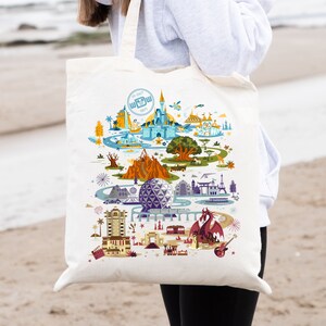 May include: A white canvas tote bag with a colorful illustration of Walt Disney World landmarks, including Cinderella's Castle, Spaceship Earth, and the Tree of Life. The text "Walt Disney World" and "15 OCT 1971" are printed on the bag.