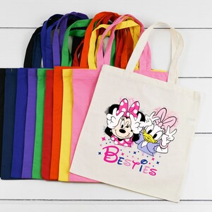 May include: A set of 10 colourful tote bags with a design featuring Minnie Mouse and Daisy Duck with the text "Besties".