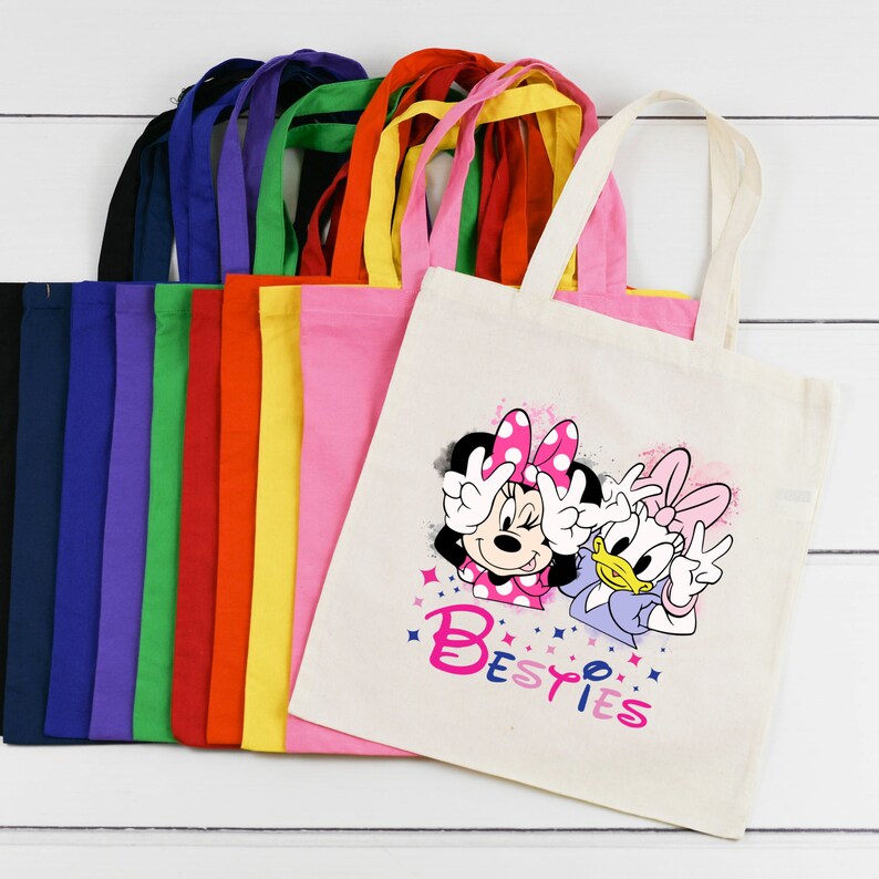 May include: A set of 10 colourful tote bags with a design featuring Minnie Mouse and Daisy Duck with the text "Besties".