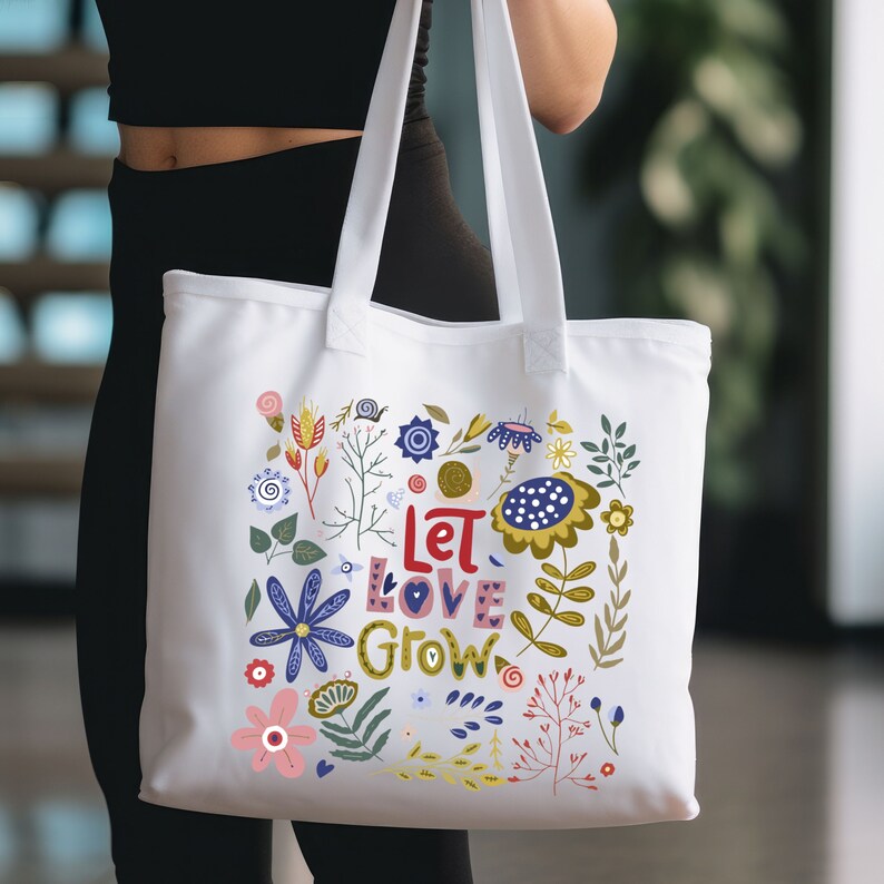 May include: White canvas tote bag with a floral design and the text "Let Love Grow".