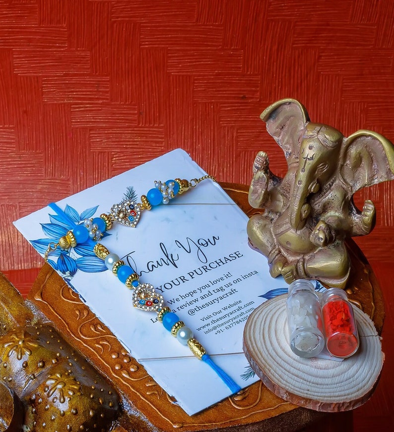 Handcrafted Rakhi Gift Hampers: Mosaic Hanging Lamps, Elephant Wooden Stool, Rakhis & Ganesh Statue A Perfect Blend of Art and Tradition image 3