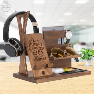 May include: A wooden organizer with a phone stand, headphone holder, watch holder, sunglasses holder, and a small shelf for other items. The organizer is engraved with the text "Best Engineer Ever" and the name "Thomas".