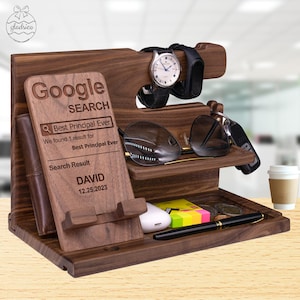 May include: A wooden organizer with a phone stand, watch holder, glasses holder, and a small compartment for keys. The organizer has a personalized message that says "Google Search Best Principal Ever" and "Search Result DAVID 12.25.2023".