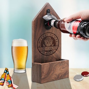 May include: Wooden bottle opener with a built-in bottle cap catcher. The opener is engraved with a United States Army seal, the name "Rodriguez", and the date "10.22.2021".