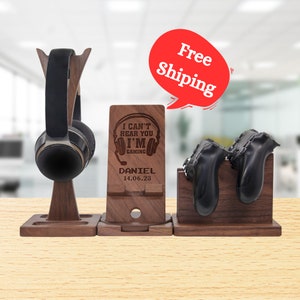 May include: Wooden stand with a headset holder, a phone stand, and two controller holders. The phone stand has the text "I can't hear you I'm gaming" and "Daniel 14.06.23" engraved on it.