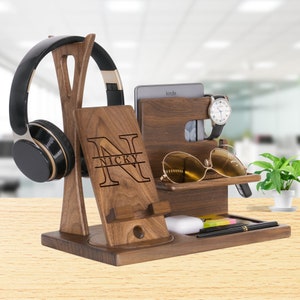 May include: Walnut wood desktop organizer with a phone stand, headphone holder, watch holder, sunglasses holder, and a small shelf for other items. The organizer is personalized with the name "NICKY" in a large letter N.