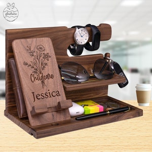 May include: A wooden organizer with multiple compartments for holding a phone, watch, sunglasses, keys, and other items. The organizer is personalized with the text "Childcare Jessica" and a floral design.