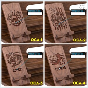 May include: Four wooden phone stands with different designs. Each stand features a personalized name, a flag, and tools. The stands are made of dark brown wood and have a slot for holding a phone.