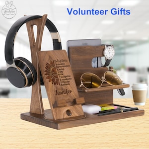 May include: A wooden desk organizer with a phone stand, headphone holder, watch holder, sunglasses holder, and a small shelf. The organizer is engraved with the words "Volunteer" and "You Are" followed by a list of positive attributes. The name "Jennifer" is engraved at the bottom.