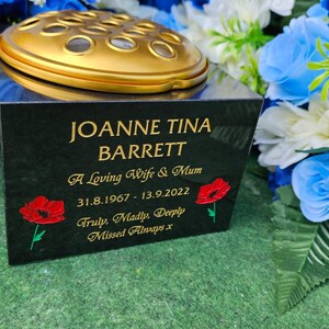 May include: Black granite memorial with a gold vase and inscription: Joanne Tina Barrett, A Loving Wife & Mum, 31.8.1967-13.9.2022, Truly, Madly Deeply Missed Always x.
