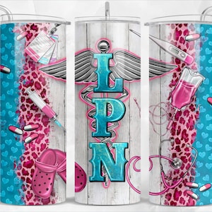 May include: A white tumbler with a blue and pink leopard print design. The tumbler features a medical caduceus symbol with the letters LPN in blue and white. Other medical symbols include a stethoscope, a syringe, a thermometer, and a pill bottle.