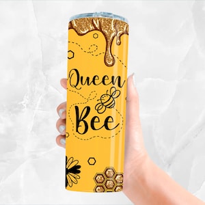 May include: A yellow tumbler with a gold glitter design and the text "Queen Bee" with a bee illustration.