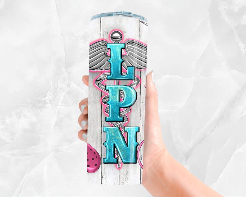 May include: White stainless steel tumbler with a wood grain pattern. The tumbler features a blue and pink medical caduceus symbol with the letters "LPN" in the center.