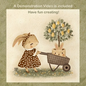 May include: A brown bunny in a brown and white polka dot dress pushes a wheelbarrow with a lemon tree and a bunny inside. The text "A Demonstration Video is included" and "Have fun creating!" is above the image.
