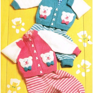 May include: Two knitted baby outfits with bear appliques. The first outfit is blue with white stripes and the second is pink with white stripes. Both outfits have white sleeves and a button closure.