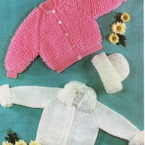 May include: Two knitted baby cardigans, one pink and one white. The pink cardigan has a fluffy texture and the white cardigan has a fluffy collar. Both cardigans have button closures.
