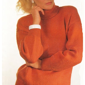 May include: A woman wearing a bright orange turtleneck sweater with long sleeves and white pants.