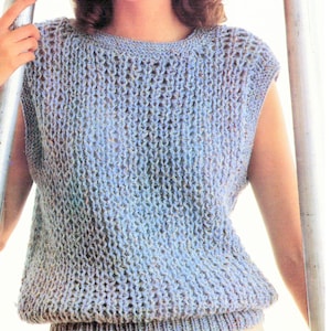 May include: A light blue sleeveless knitted top with a loose, open stitch pattern. The top has a round neckline and a ribbed hem.