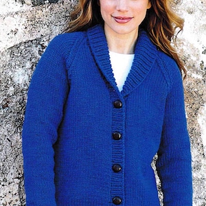 May include: A blue knitted cardigan with a shawl collar and button closure. The cardigan is made of a soft, textured yarn.