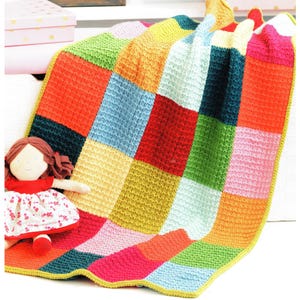May include: A colourful knitted baby blanket with a patchwork design. The blanket is made up of squares in various colours, including red, orange, yellow, green, blue, and pink. The blanket is edged with a yellow border.