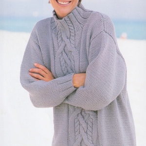 May include: A light grey cable knit jumper with a high neck and long sleeves.